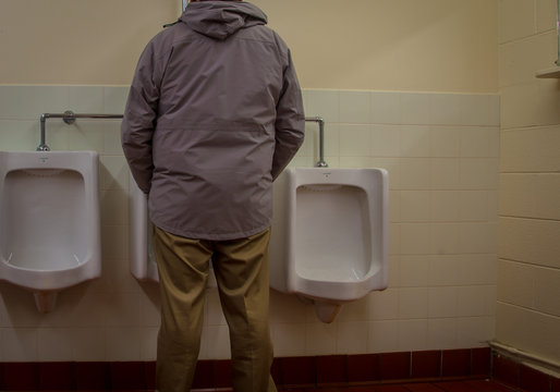 Man Using The Urinal 