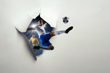 Paper breakthrough hole effect and soccer players. Mixed media