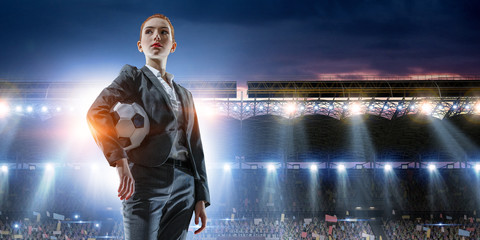 Business lady on football stadium. Mixed media