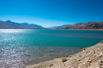 Pamir Mountains, Tajikistan - Aug 21 2018: Yashilkul Lake in Gorno-Badakhshan, Tajikistan. It is located in the World Heritage Site Tajik National Park (Mountains of the Pamirs).