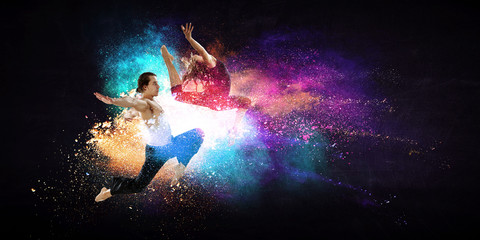 Young modern ballet dancers in a jump. Mixed media