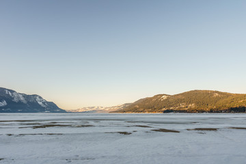 Cold morning landscape of frozen Little Shuswap Lake British Columbia Canada.