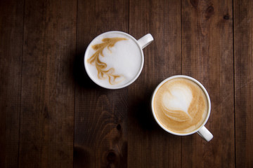 Cup of coffee close up, on a brown wooden table.