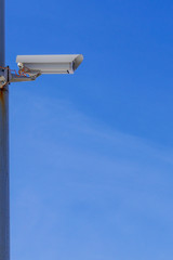 Security camera against the blue sky are monitoring.