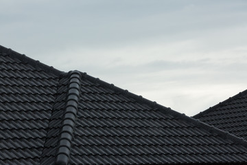 rain storm downpour on black roof tile of residential house