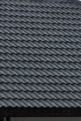 rain storm downpour on black roof tile of residential house
