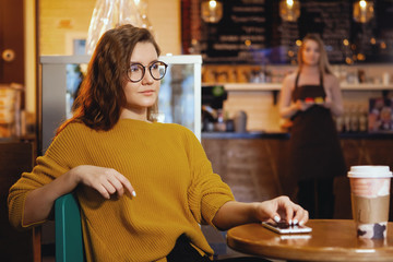Portrait of beautiful young woman using her digital tablet in cafe.