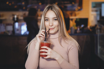 Portrait of beautiful young woman using her digital tablet in cafe.