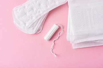 Sanitary pad and menstrual tampon on a pink background - obrazy, fototapety, plakaty