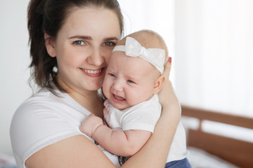 Mom holds the baby daughter.