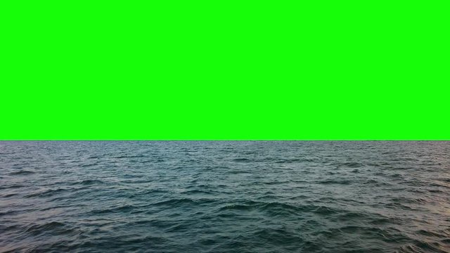 4K Video Landscape point of view tracking shot from side view of a passenger ferry boat as it travels across waving sea water surface in summer with chroma key green screen 
