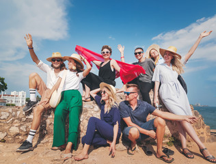 Group of young stylish happy friends travel together, friendship community