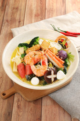 Shrimp and dry mushrooms spicy hot pot in a white ceramic dish