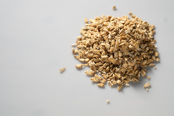 Fototapeta na wymiar raw syrodavlennaya oatmeal on a white background, top view, space for text