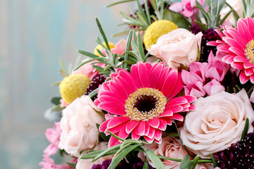 Red and pink bouquet with roses, gerberas, carnations and freesias.