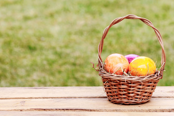 Traditional Easter basket with colorful eggs.