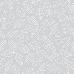 Vector seamless pattern with white leaves silhouettes on a grey background