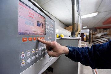 carpenter calculating and programming a cnc wood working machine