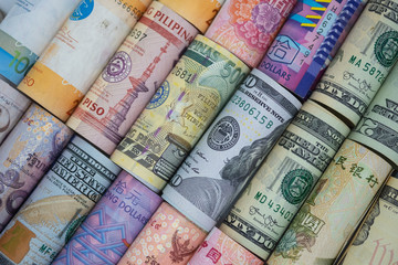 Closeup rolled of variety banknote around the world. Exchange rate and Forex investment...