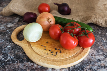 Fresh vegetables - onions, tomatoes, cucumber on a table