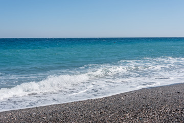 Waves Washing Ashore on a Black Sand Volcanic Beach in Sicily