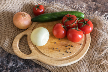 Fresh vegetables - onions, tomatoes, cucumber on a table