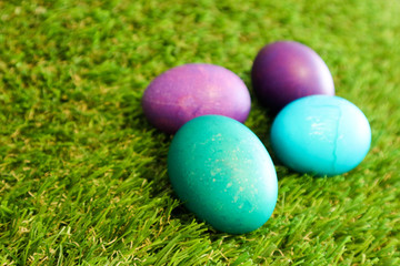 Fototapeta na wymiar Blue and azure easter eggs in the green grass