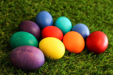 Fototapeta na wymiar Beautiful bright colorful easter eggs in green grass closeup