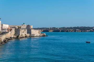 Fototapeta na wymiar View of the Still Mediterranean Sea and Syracuse, Sicily, Italy