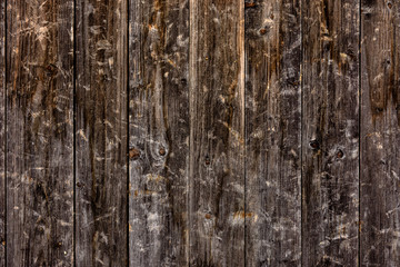 Obraz premium The look of a wooden wall from the boards, a beautiful texture, a village.