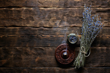 Dried lavender flower branch on a wooden table background with copy space. Herbal medicine concept.