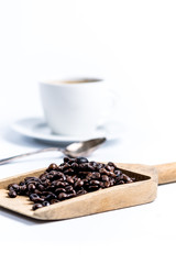 wooden scoop with coffee bean on white