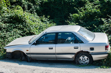 Old crushed cars bodies stored in auto wrecking junk yard for scrap and spare parts