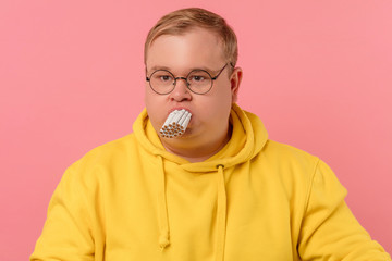 Stressed corpulent man trying to smoke a whole pile of cigarettes simultaneously, killing his...