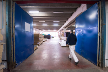 carpenter walking through factory