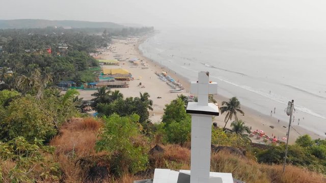 Aerial view christian cross on a hill in Arambol, India.