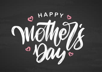 Handwritten brush lettering composition of Happy Mother's Day on chalkboard background.
