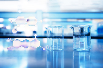 two glass beaker with chemical structure with blue chemical science laboratory background