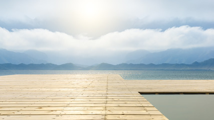 Wooden floor platform and lake with sky background