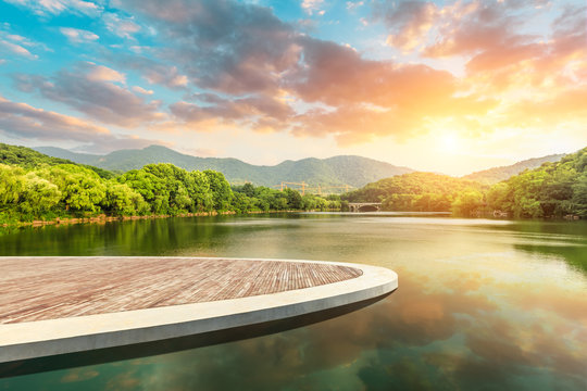 Wooden floor platform and lake with green mountains background in Hangzhou