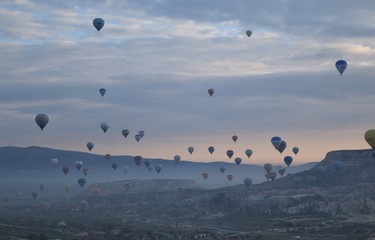 Sunrise and balloons. Beautiful background of the balloon and the sunset.Cappadocia. Turkey. Göreme. Nevşehir. Türkiye. 8. 04. 2019. Balloons flying over the rocky landscape in Cappadocia Turkey. 