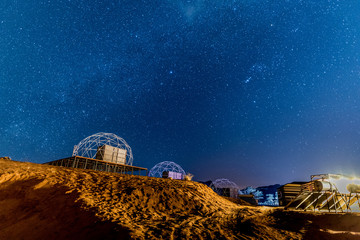 Starry night with Martian domes in a desert camp in Wadi Rum, Jordan