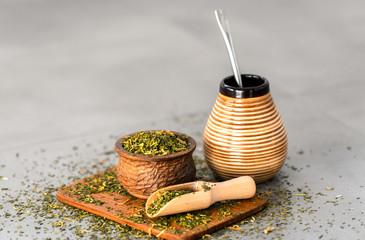 Yerba Mate tea on neutral stone gray backgrund. Healthy, energy boosting beverage drink on neutral...