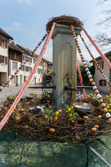 Fototapeta na wymiar festive decorations for Easter holiday on the village fountains of the small town of Maienfeld in the Swiss Alps