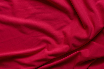 Close up of beautiful wrinkle carmine pink fabric texture