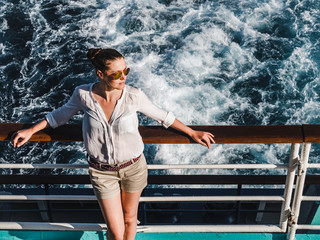 Pretty woman on empty liner deck woman on the empty deck of a cruise liner on the background of sea...