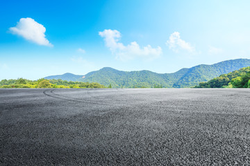 Asphalt race track ground and mountains with blue sky landscape