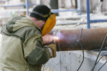 A worker with a welding machine works