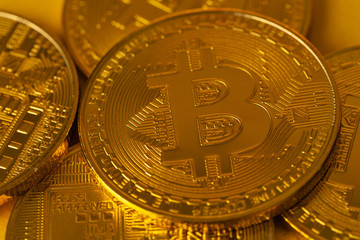 Top view closeup photo of many gold bitcoins