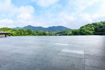 Empty square floor and green mountain with sky landscape